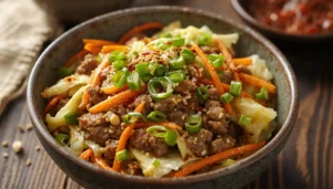 Keto egg roll in a bowl served with sesame oil and green cabbage
