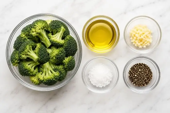 Grilled Broccoli 2 Ingredients for grilled broccoli including florets, olive oil, garlic, salt, and pepper