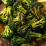 Grilled broccoli florets with charred edges served on a wooden platter