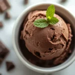 Close-up of a scoop of keto chocolate ice cream in a white bowl