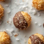 Golden keto coconut macaroon cookies on a marble board from an easy coconut macaroon cookie recipe