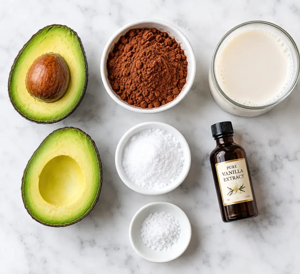 Keto Avocado Chocolate Pudding 2 Ingredients for keto avocado chocolate pudding including ripe avocados, cocoa powder, sweetener, almond milk, vanilla, and sea salt