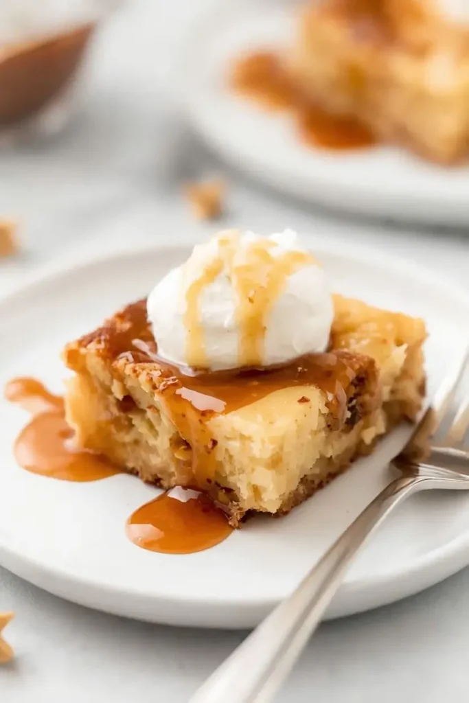 Keto Bread Pudding 4 Sliced keto bread pudding plated with whipped cream and sugar-free caramel drizzle