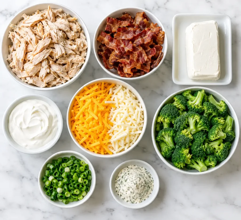 Chicken Bacon Ranch Casserole 2 Flat lay of ingredients for chicken bacon ranch casserole including chicken, bacon, cream cheese, cheese, and broccoli