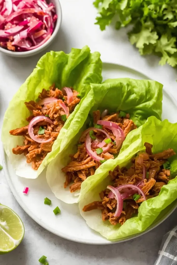 Slow Cooker Pulled Pork 4 Low-carb lettuce wraps filled with slow cooker pulled pork and pickled onions